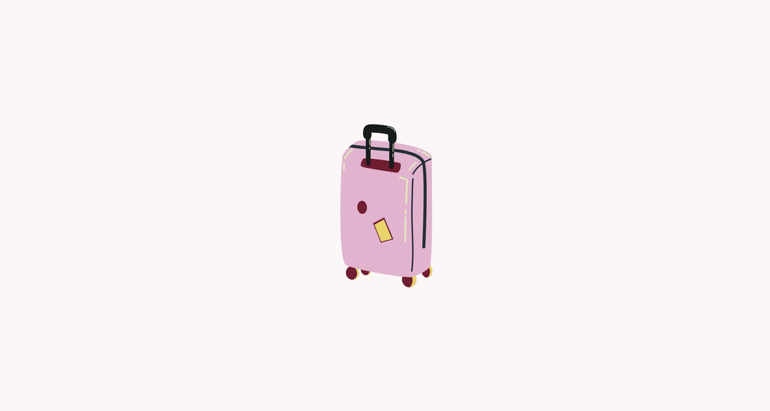 What to pack in your hospital bag when you're having a baby - suitcase on pink background 