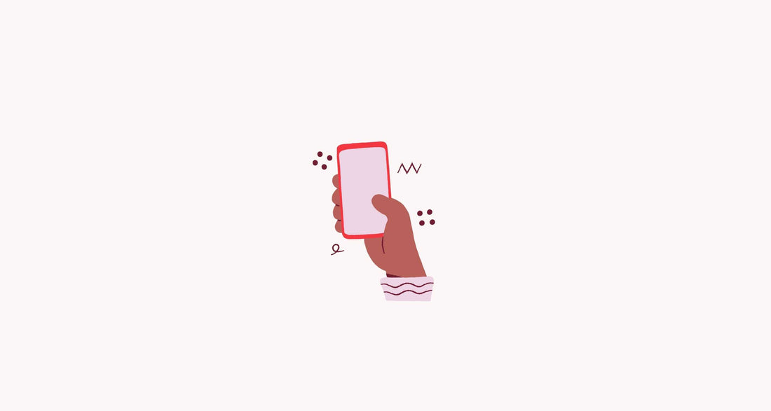 pumping apps you need to know about - hand holding mobile phone on pink background